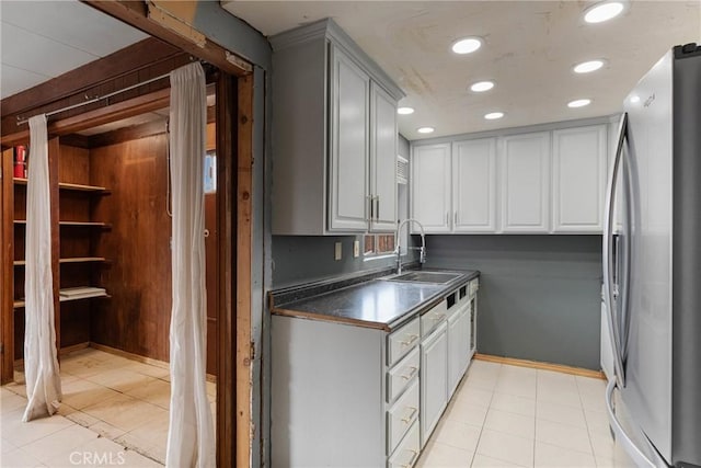 kitchen featuring sink, stainless steel fridge, and light tile patterned flooring