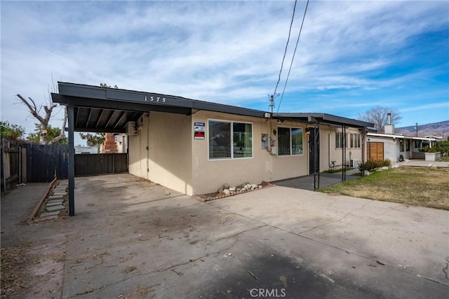 view of front of property with a carport and a front lawn