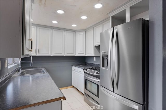 kitchen with white cabinetry, appliances with stainless steel finishes, sink, and light tile patterned floors