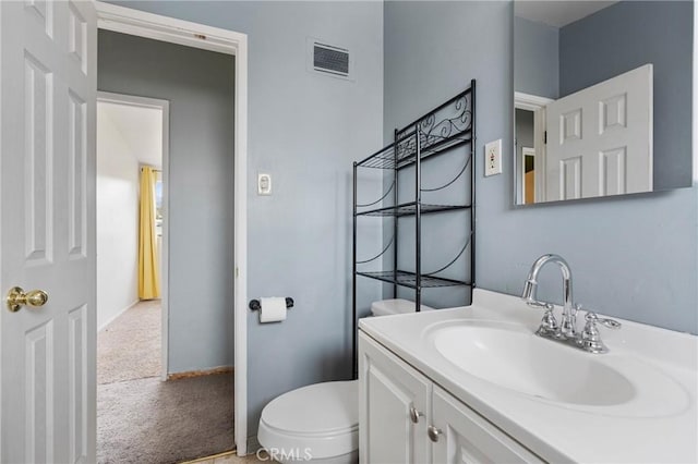 bathroom with vanity and toilet