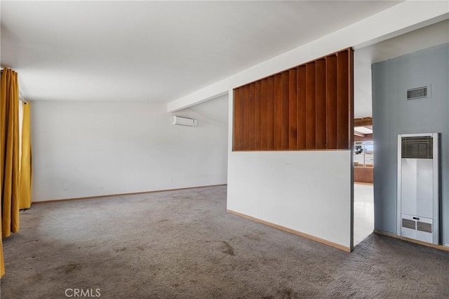 carpeted empty room featuring a wall mounted air conditioner and lofted ceiling with beams