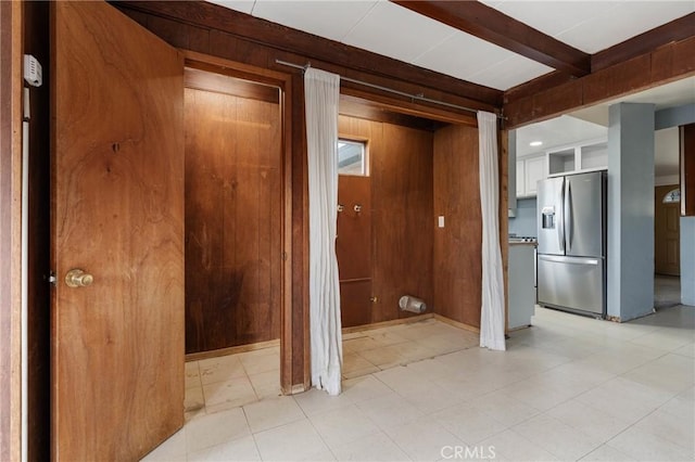 hallway with beam ceiling and wooden walls