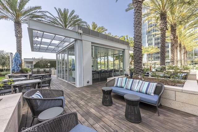 deck featuring outdoor dining area and outdoor lounge area