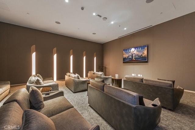 home theater featuring arched walkways, carpet flooring, and recessed lighting