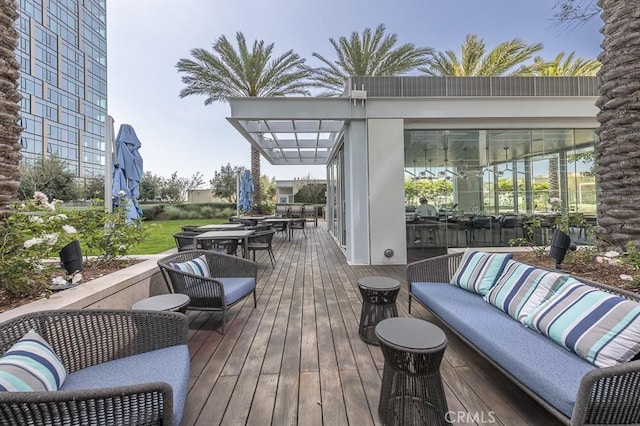 wooden terrace featuring an outdoor hangout area and outdoor dining space