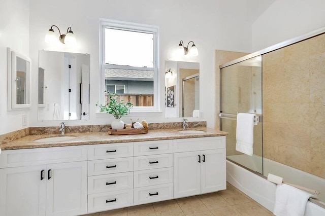 bathroom featuring tile patterned floors, shower / bath combination with glass door, and vanity