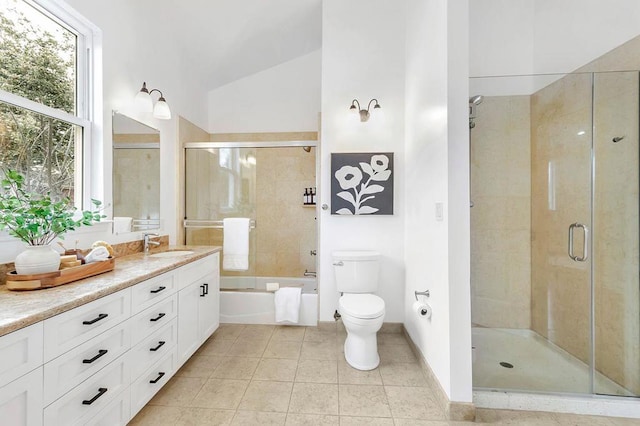 full bathroom featuring toilet, shower with separate bathtub, vaulted ceiling, vanity, and tile patterned flooring