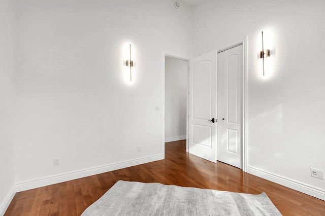 spare room with dark wood-type flooring