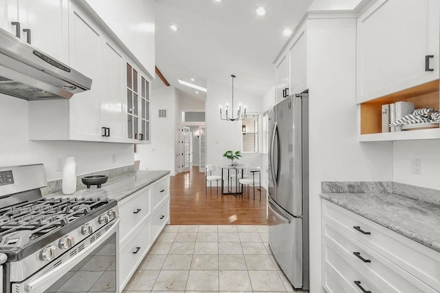 kitchen with white cabinetry, appliances with stainless steel finishes, and light stone countertops