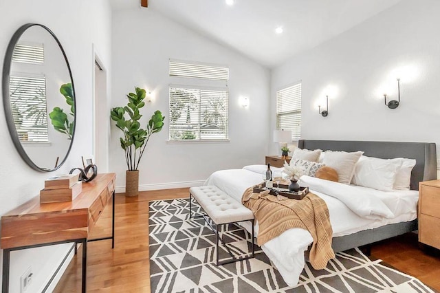 bedroom with high vaulted ceiling and light hardwood / wood-style floors