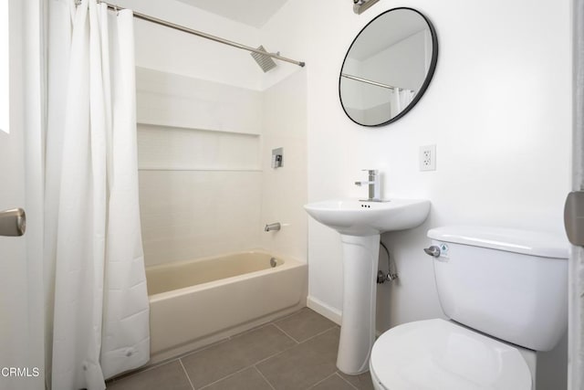 bathroom featuring tile patterned flooring, toilet, and shower / bath combo with shower curtain