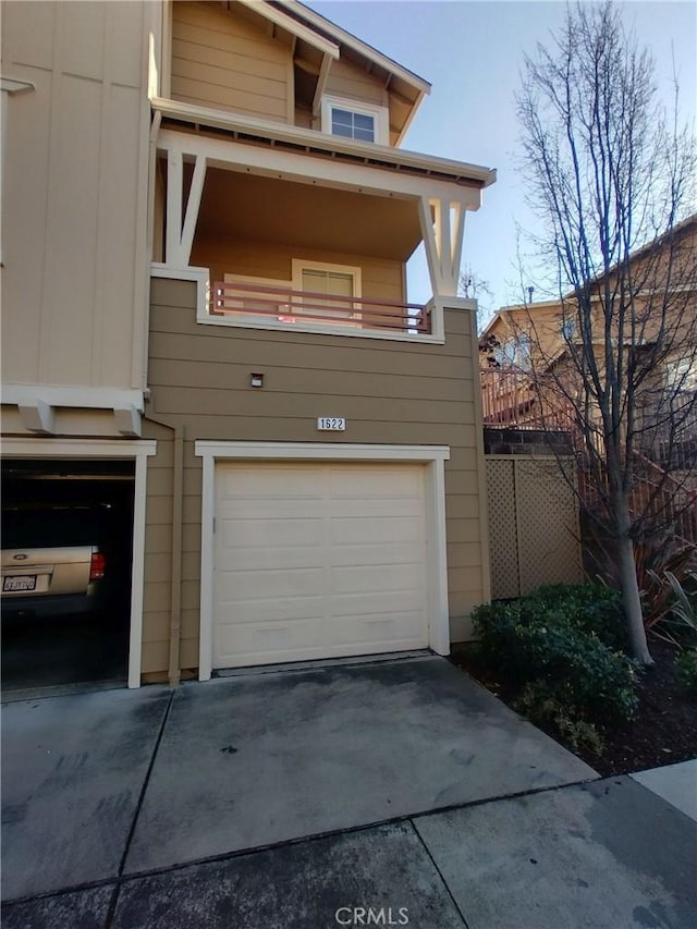 view of front of home featuring a garage and a balcony