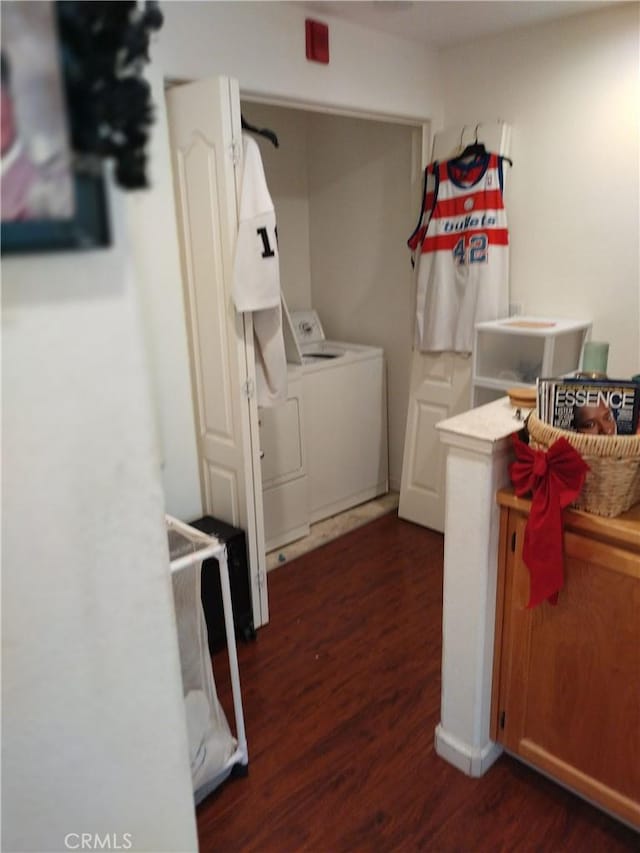 washroom featuring dark hardwood / wood-style floors and washing machine and clothes dryer