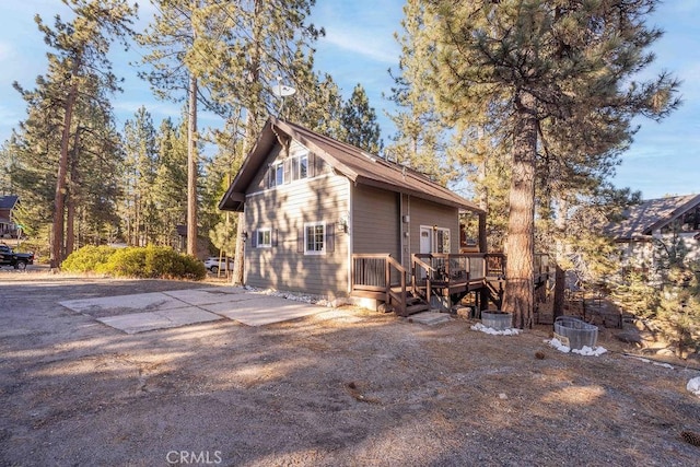 view of property exterior with a deck