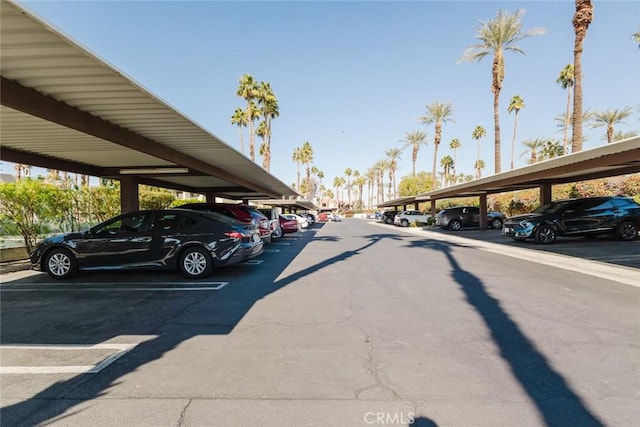 view of parking / parking lot featuring a carport