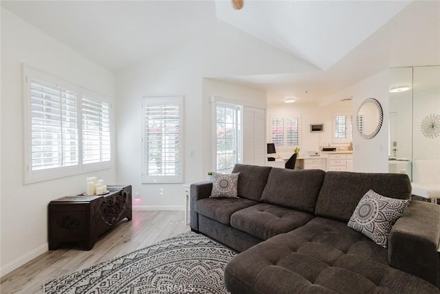 living room with lofted ceiling and light hardwood / wood-style flooring