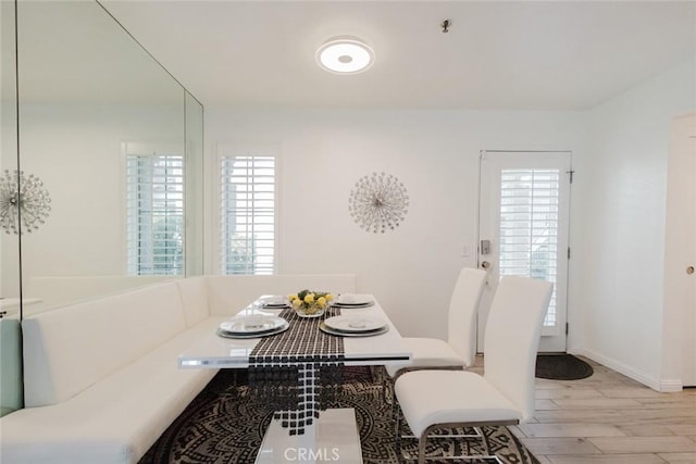 dining area with light hardwood / wood-style floors and breakfast area