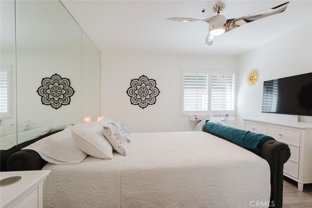 bedroom with ceiling fan and light hardwood / wood-style floors