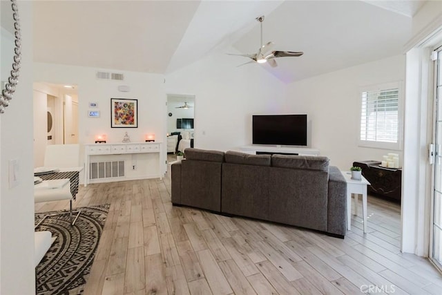 living room featuring light hardwood / wood-style flooring, high vaulted ceiling, and ceiling fan