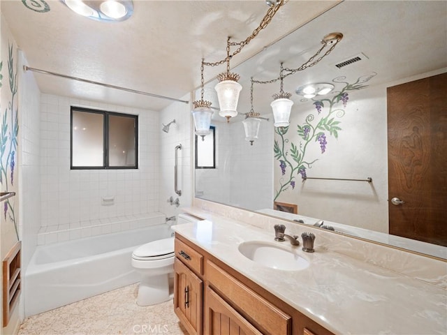 full bathroom featuring vanity, tiled shower / bath combo, and toilet