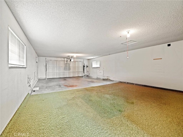 interior space featuring a textured ceiling and carpet flooring