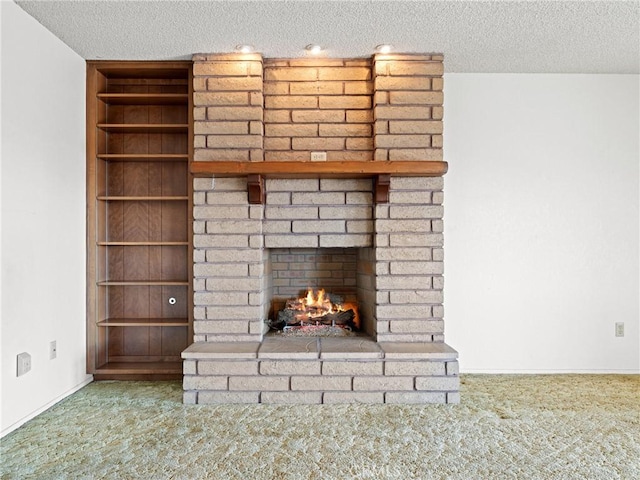 interior details featuring a fireplace, carpet floors, and a textured ceiling