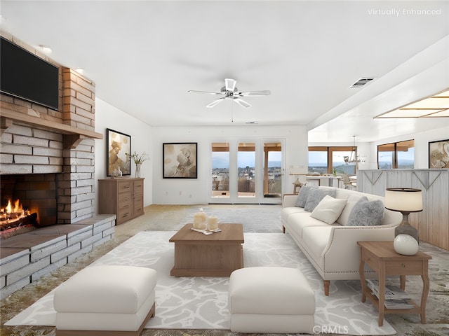 carpeted living room with ceiling fan and a brick fireplace