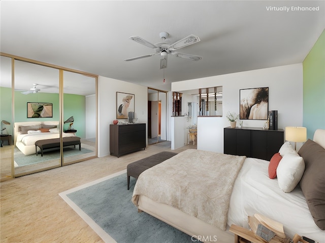 bedroom with connected bathroom, light carpet, and ceiling fan