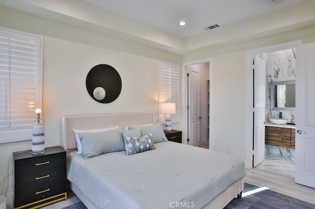 bedroom with light wood-style flooring, visible vents, and recessed lighting