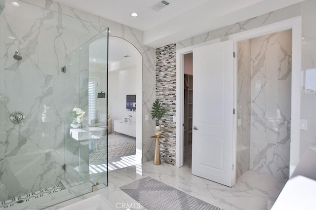 bathroom with marble finish floor, stone wall, a marble finish shower, and visible vents