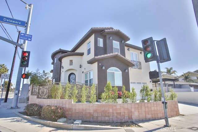 exterior space with a garage, driveway, and stucco siding