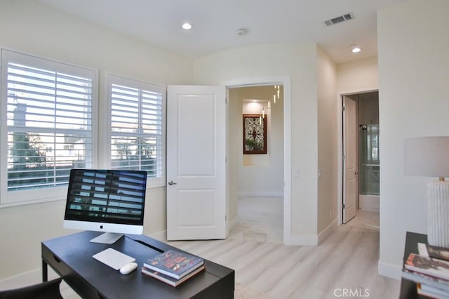 office featuring light wood-type flooring, visible vents, baseboards, and recessed lighting