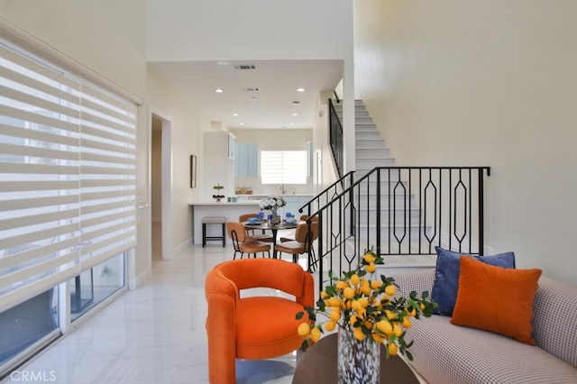 sitting room featuring baseboards, visible vents, marble finish floor, stairs, and recessed lighting