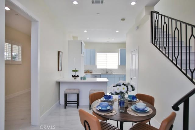 dining area with baseboards, stairway, and recessed lighting