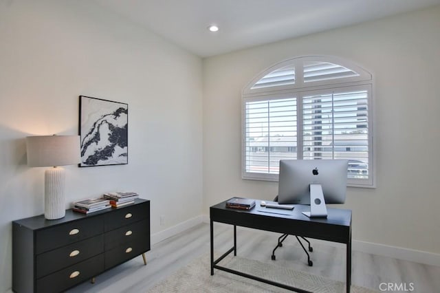 office area featuring light wood-style flooring and baseboards