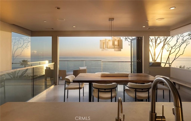 dining space featuring a water view