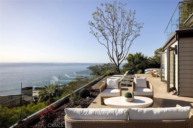 balcony with outdoor lounge area and a water view