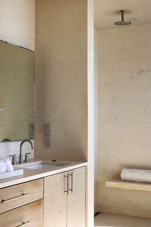 bathroom with tasteful backsplash and vanity