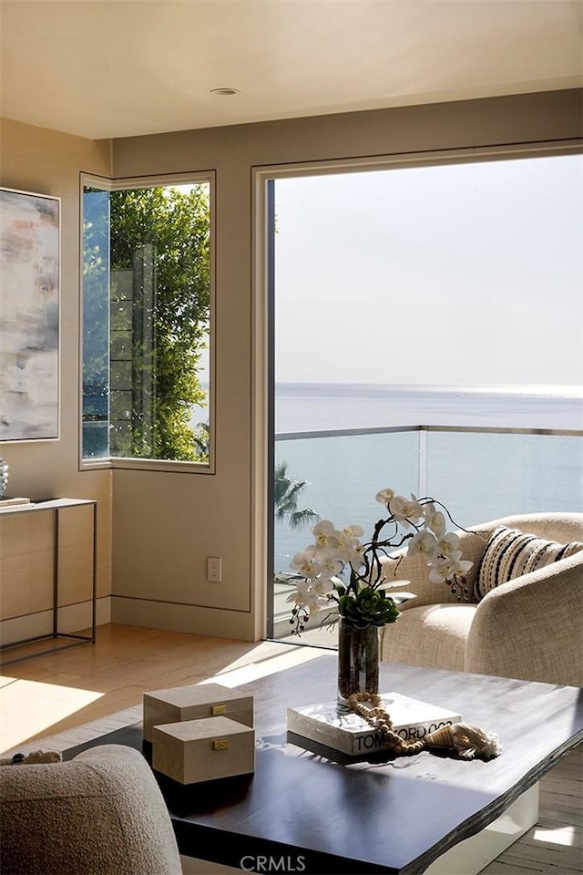 interior space with a water view and light wood-type flooring