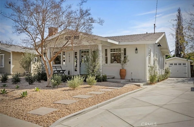 bungalow-style house with an outbuilding and a detached garage