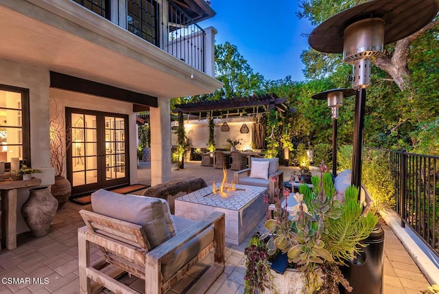 view of patio featuring a pergola, french doors, a balcony, and an outdoor fire pit