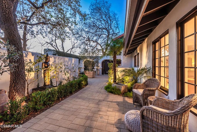 view of patio terrace at dusk