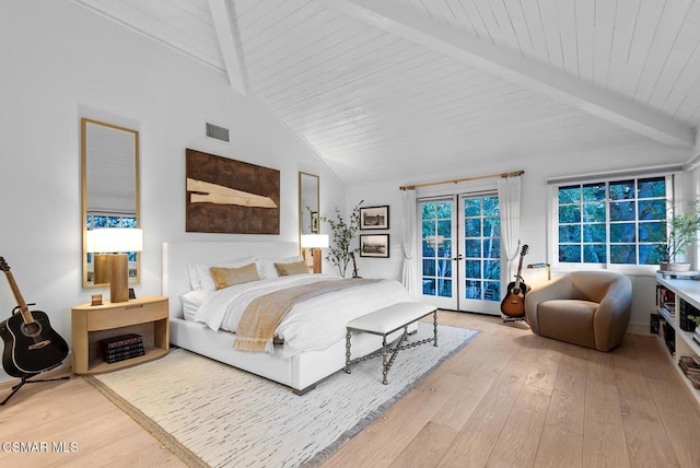 bedroom featuring access to exterior, beam ceiling, french doors, and light wood-type flooring