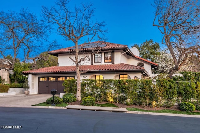 mediterranean / spanish house featuring a garage