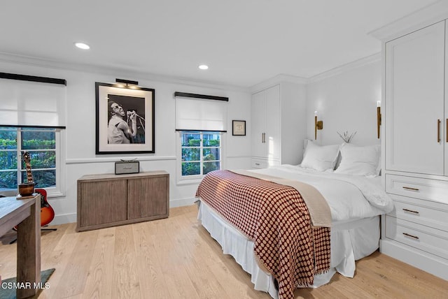 bedroom featuring ornamental molding and light hardwood / wood-style floors