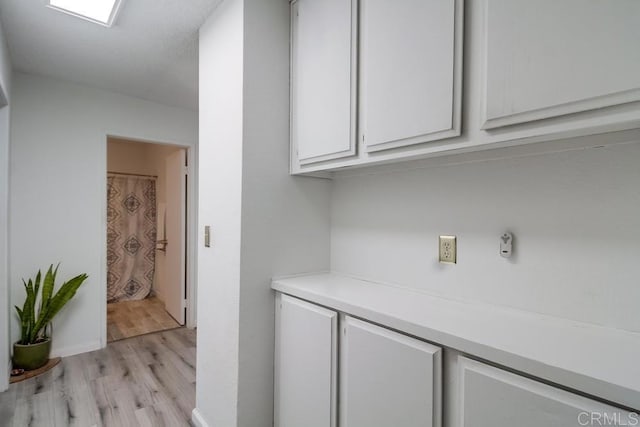 interior space featuring white cabinetry and light wood-type flooring