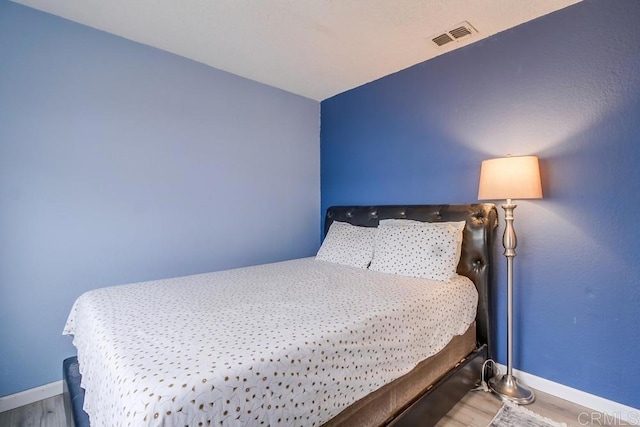 bedroom with wood-type flooring