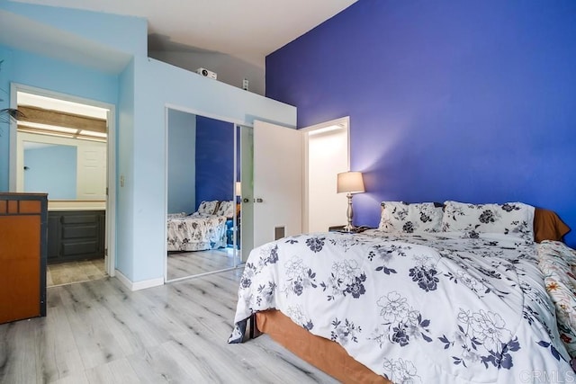 bedroom with wood-type flooring and a closet