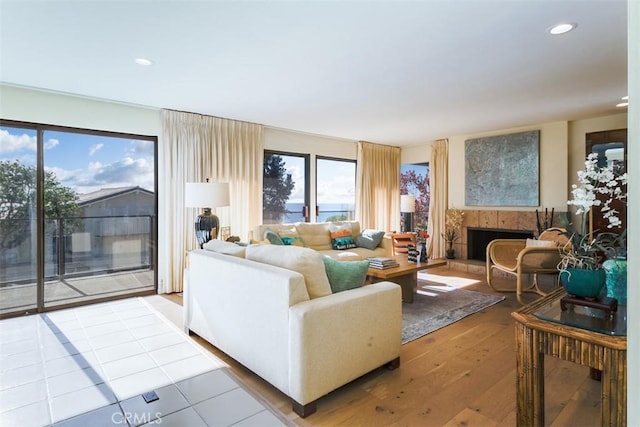 living room featuring hardwood / wood-style flooring and a tile fireplace