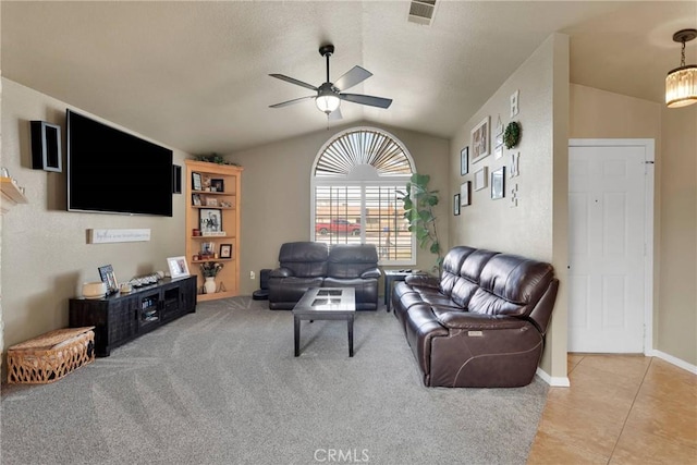 living room with vaulted ceiling, light tile patterned floors, and ceiling fan